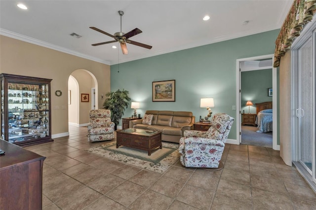 tiled living room with crown molding and ceiling fan