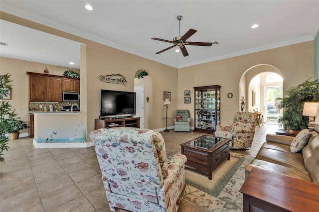 tiled living room with crown molding and ceiling fan