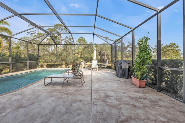 exterior space featuring grilling area and glass enclosure