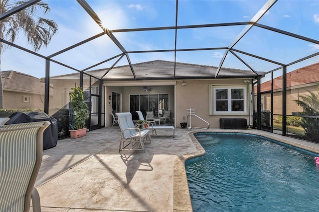 view of pool featuring ceiling fan, a grill, a lanai, and a patio area