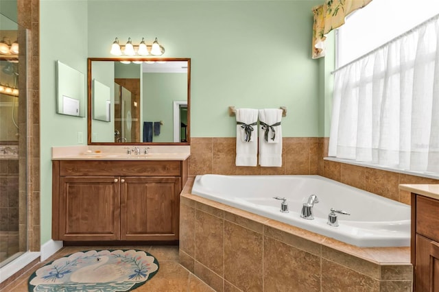 bathroom with vanity, plenty of natural light, and separate shower and tub