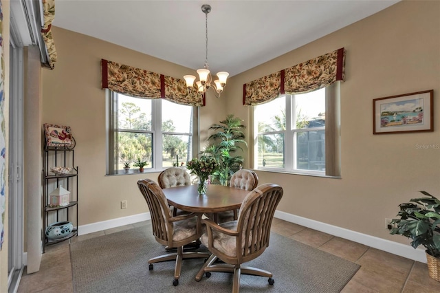 tiled dining area with a wealth of natural light and a notable chandelier