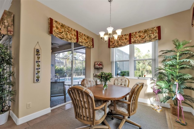 tiled dining area featuring a notable chandelier