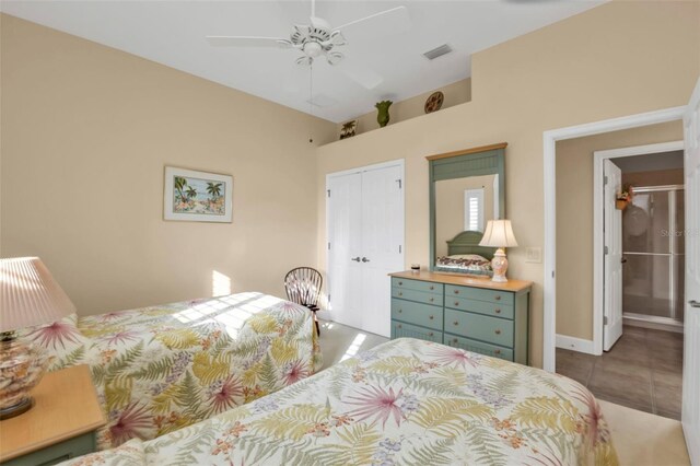 tiled bedroom featuring ceiling fan and a closet