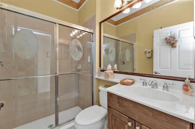 bathroom featuring walk in shower, ornamental molding, vanity, and toilet