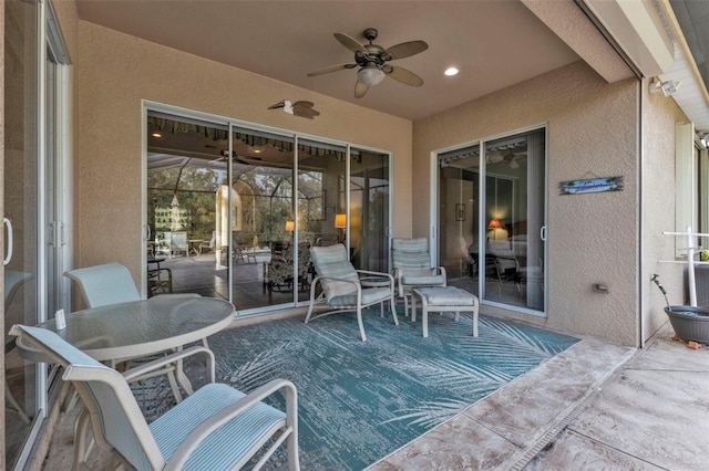 view of patio with ceiling fan and a lanai