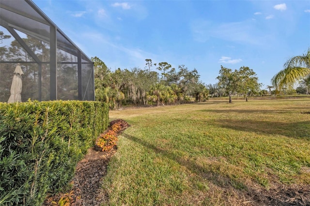 view of yard with glass enclosure