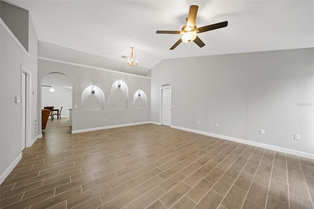 unfurnished room featuring lofted ceiling and ceiling fan with notable chandelier