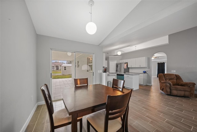 dining area with vaulted ceiling