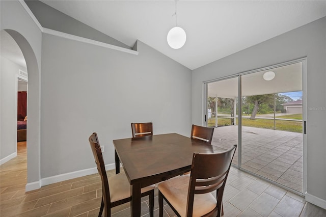 dining space featuring vaulted ceiling