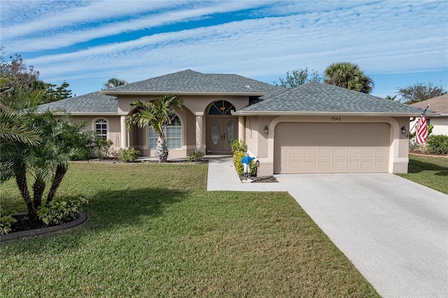 view of front of house with a garage and a front yard