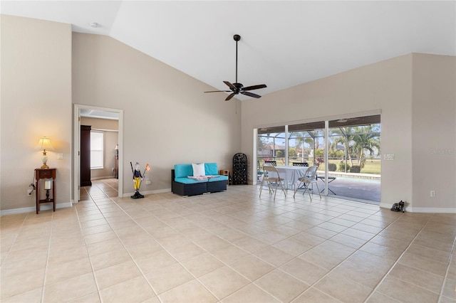 living area with lofted ceiling, light tile patterned floors, and ceiling fan