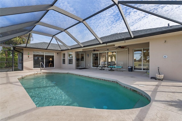 view of pool featuring ceiling fan, glass enclosure, and a patio