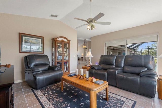 living room featuring ceiling fan, tile patterned flooring, and vaulted ceiling