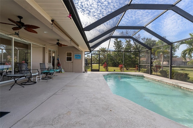 view of pool with a patio, a lanai, and ceiling fan