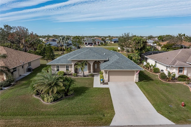 view of front facade with a garage and a front lawn