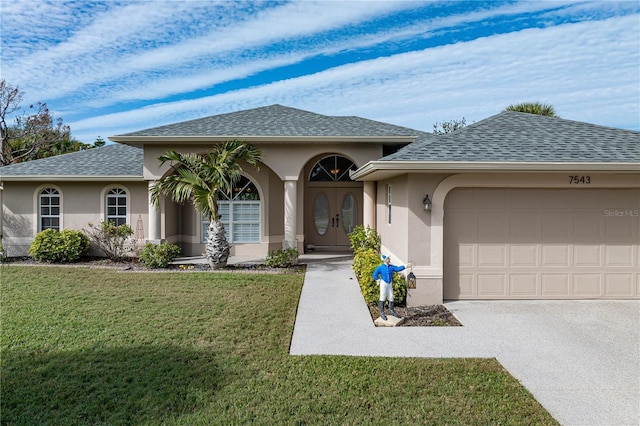 view of front facade with a garage and a front lawn