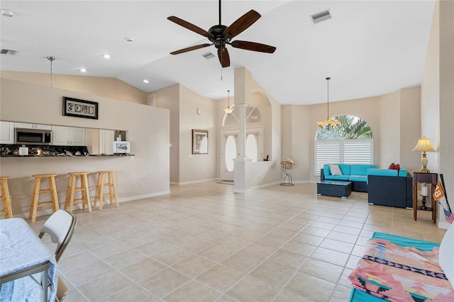 living room featuring light tile patterned floors, vaulted ceiling, and ceiling fan