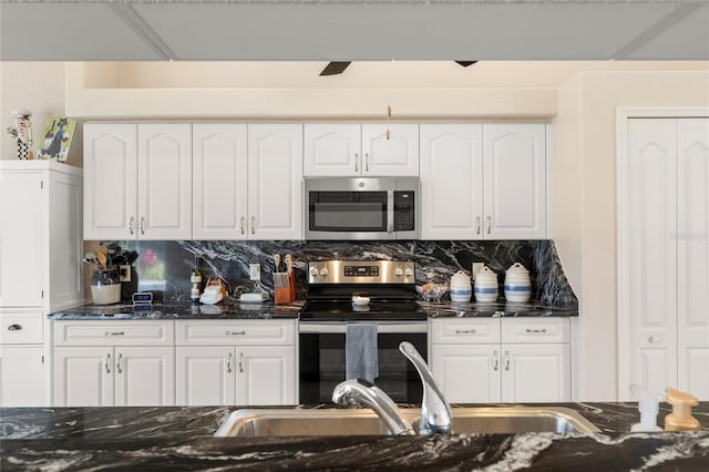 kitchen featuring backsplash, appliances with stainless steel finishes, and white cabinets