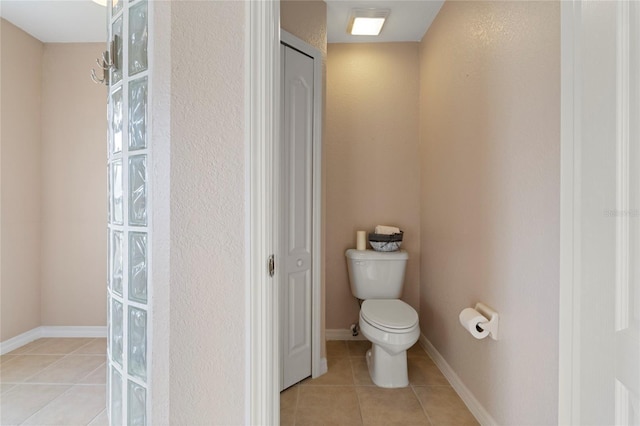 bathroom featuring tile patterned flooring and toilet