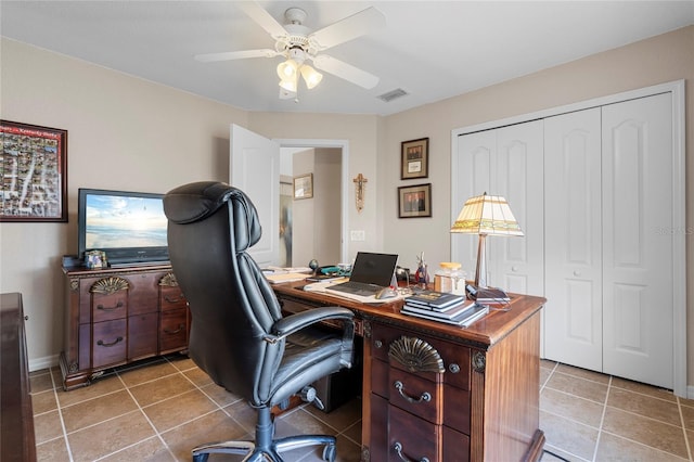 tiled office space featuring ceiling fan