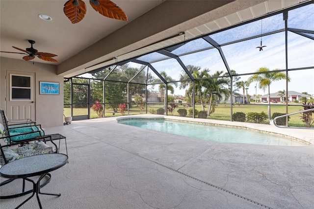 view of pool with a lanai, a patio, and ceiling fan