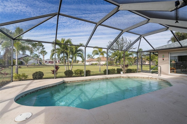 view of swimming pool featuring a yard, a lanai, and a patio area