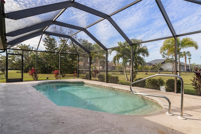 view of pool featuring a yard, a patio area, and glass enclosure