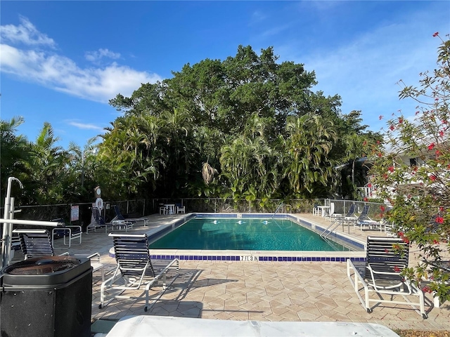 pool with fence and a patio