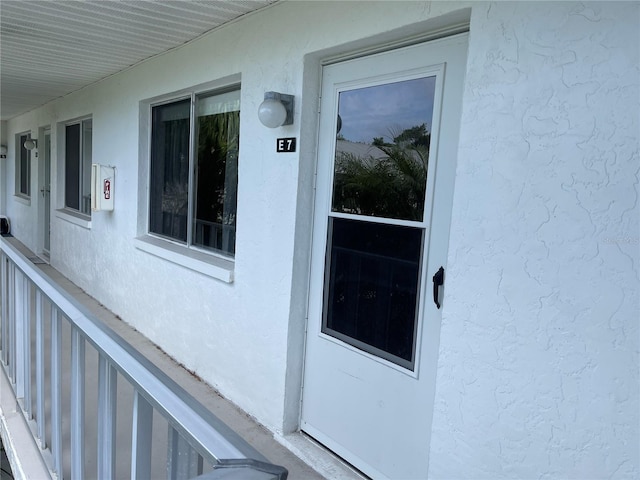 entrance to property with stucco siding