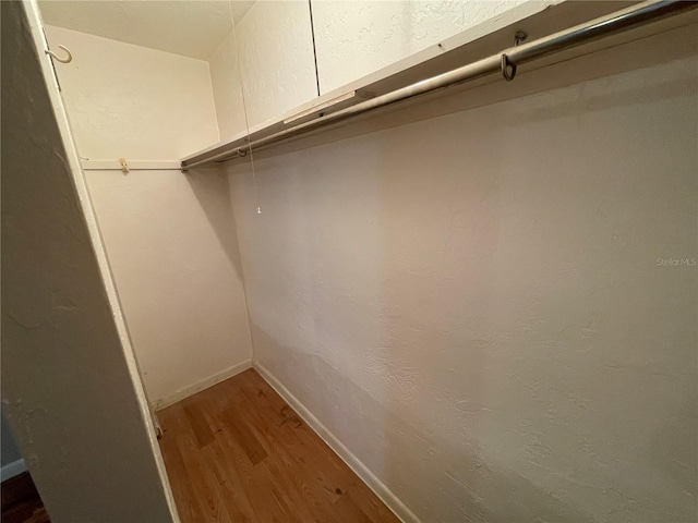 walk in closet featuring wood finished floors