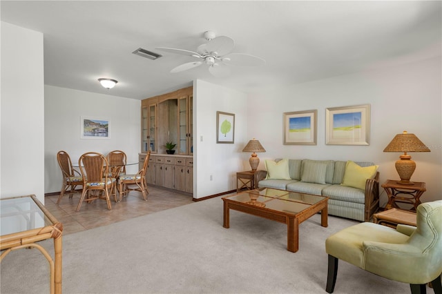 living room featuring ceiling fan and light tile patterned floors