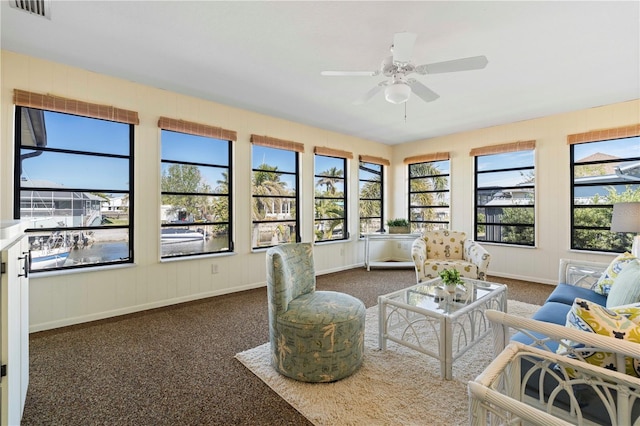 living room with dark colored carpet and ceiling fan