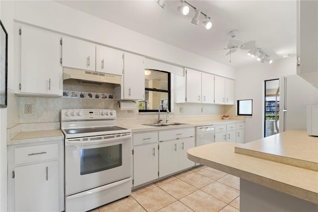 kitchen featuring white cabinetry, sink, white appliances, and light tile patterned flooring