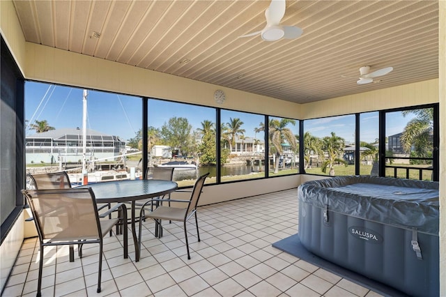 sunroom / solarium featuring a water view, ceiling fan, and wood ceiling