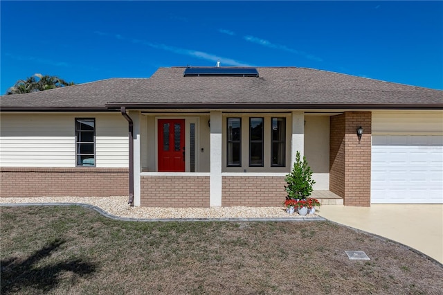 single story home featuring a garage and solar panels