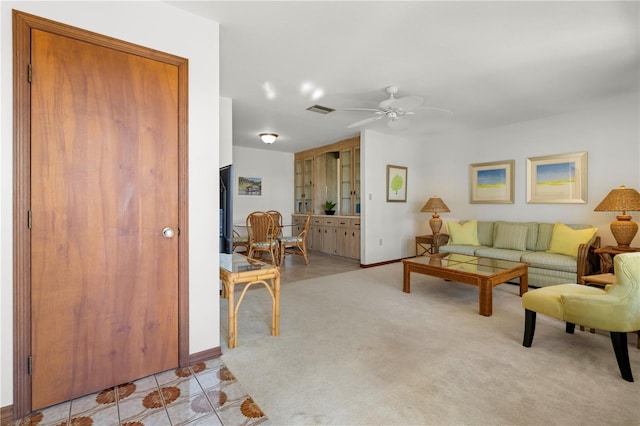 living room with light colored carpet and ceiling fan