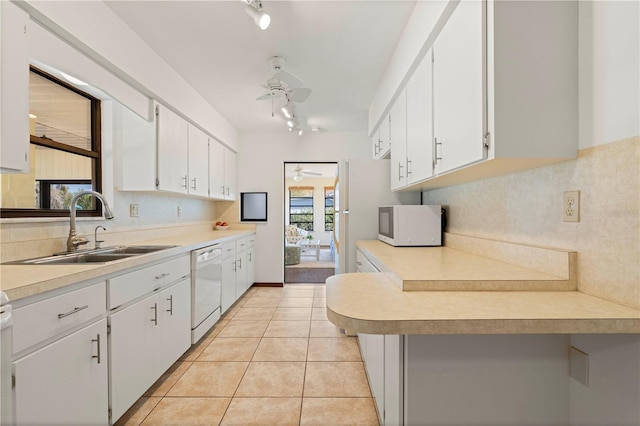 kitchen featuring sink, white appliances, ceiling fan, white cabinetry, and light tile patterned flooring