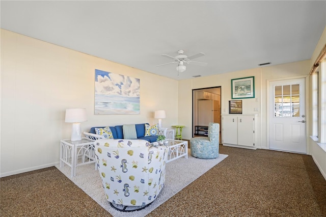 living room featuring ceiling fan and carpet flooring