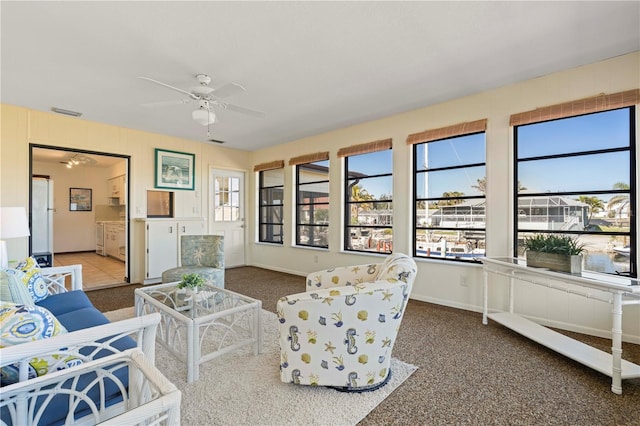 carpeted living room featuring ceiling fan