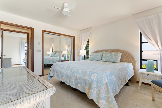 carpeted bedroom featuring ceiling fan and a closet