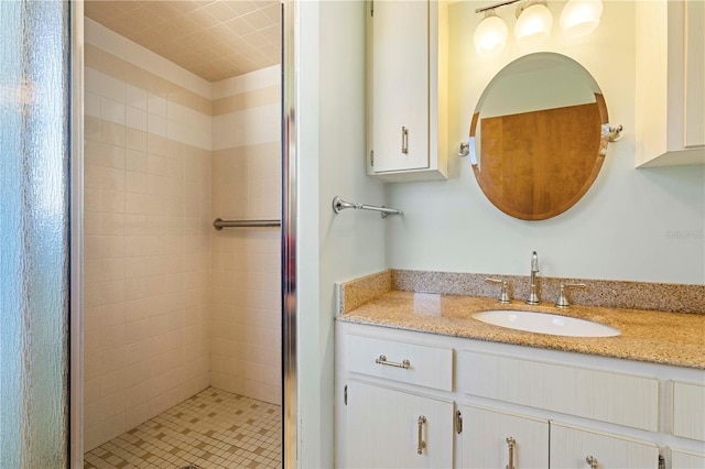 bathroom featuring vanity and a shower with door