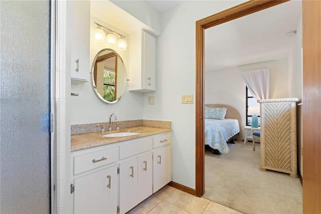 bathroom with an enclosed shower, vanity, and tile patterned floors