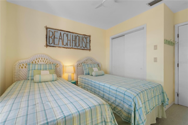 carpeted bedroom featuring a closet and ceiling fan