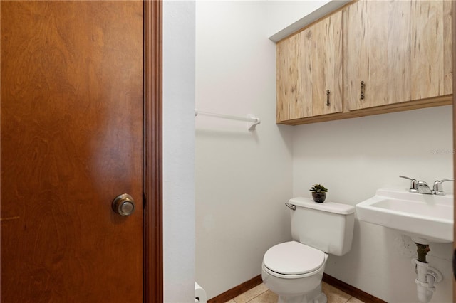 bathroom with tile patterned flooring and toilet