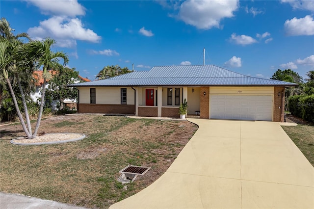 520 Boardman Dr, Punta Gorda, FL 33950 - single story home with concrete driveway, an attached garage, brick siding, and metal roof