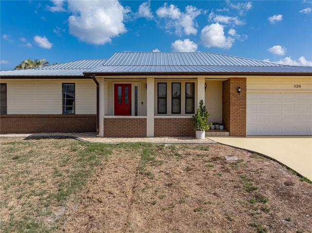 520 Boardman Dr, Punta Gorda, FL 33950 - single story home featuring driveway, metal roof, a porch, a garage, and brick siding