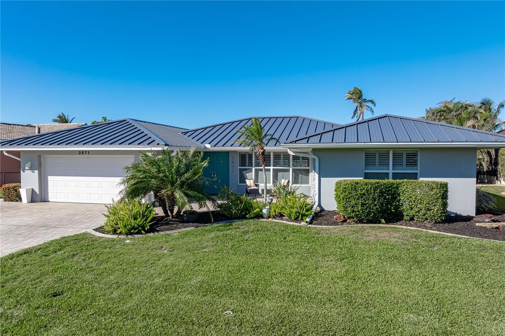 2871 Coral Way, Punta Gorda, FL 33950 - ranch-style home featuring a garage and a front lawn