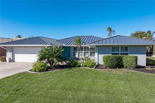 ranch-style home featuring a garage and a front lawn