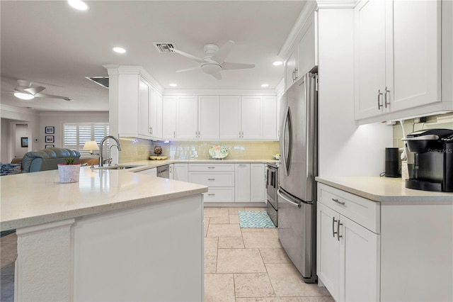 kitchen featuring ceiling fan, kitchen peninsula, sink, and white cabinets